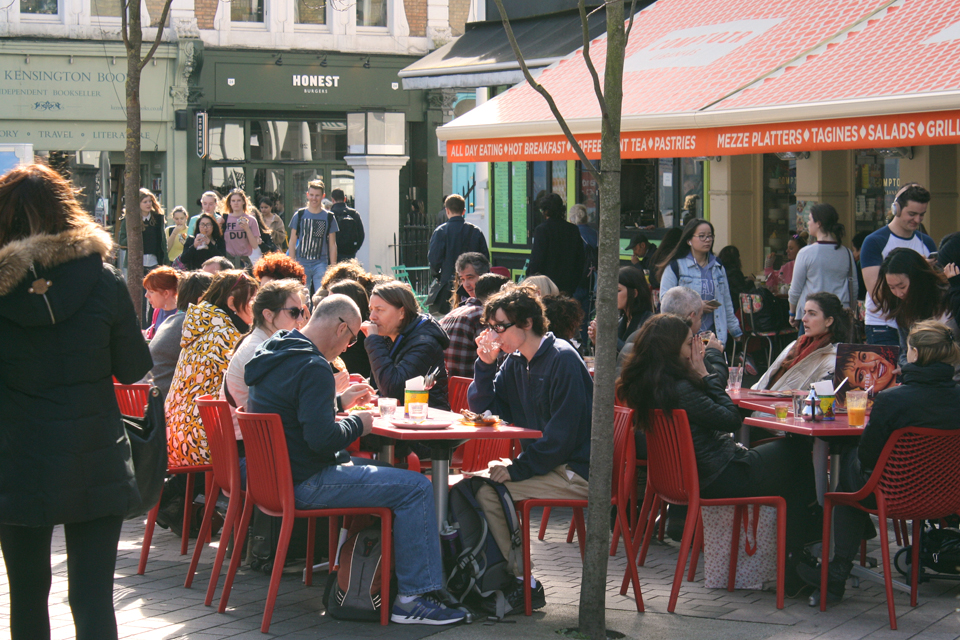 People eating at multiple tables at a restaurant at South Kensington.